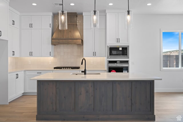 824 S 1690 W, Hurricane, UT 84737 - kitchen with stainless steel oven, wall chimney exhaust hood, a sink, light wood finished floors, and recessed lighting