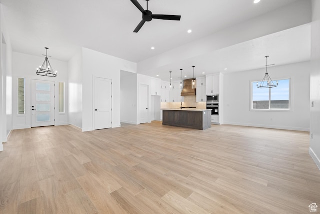 824 S 1690 W, Hurricane, UT 84737 - unfurnished living room featuring a chandelier, baseboards, a ceiling fan, recessed lighting, and light wood finished floors