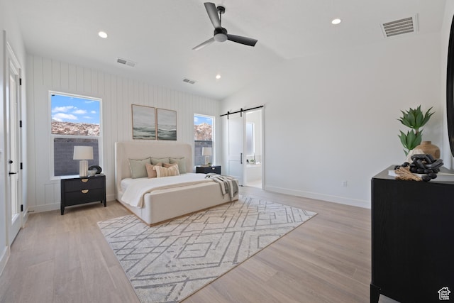 824 S 1690 W, Hurricane, UT 84737 - bedroom featuring light wood-type flooring, multiple windows, a barn door, recessed lighting, and lofted ceiling
