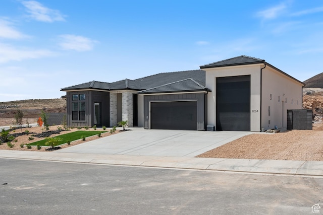 824 S 1690 W, Hurricane, UT 84737 - view of front facade with an attached garage, driveway, a tiled roof, board and batten siding, and stucco siding