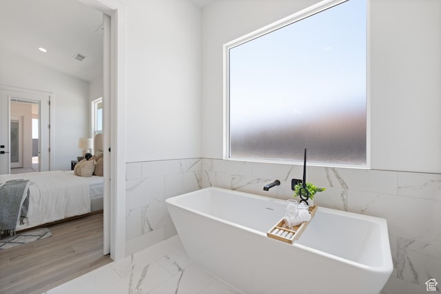 824 S 1690 W, Hurricane, UT 84737 - bathroom with a soaking tub, tile walls, marble finish flooring, ensuite bath, and wainscoting