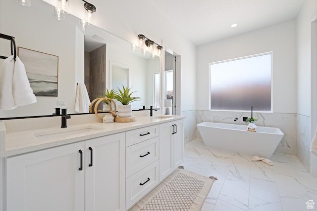 824 S 1690 W, Hurricane, UT 84737 - full bath featuring double vanity, a freestanding bath, marble look tiles, recessed lighting, and wainscoting