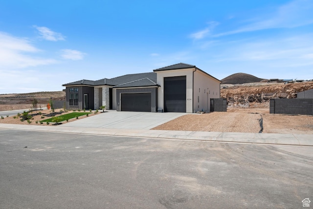 824 S 1690 W, Hurricane, UT 84737 - view of front facade featuring an attached garage, concrete driveway, stucco siding, and a tile roof