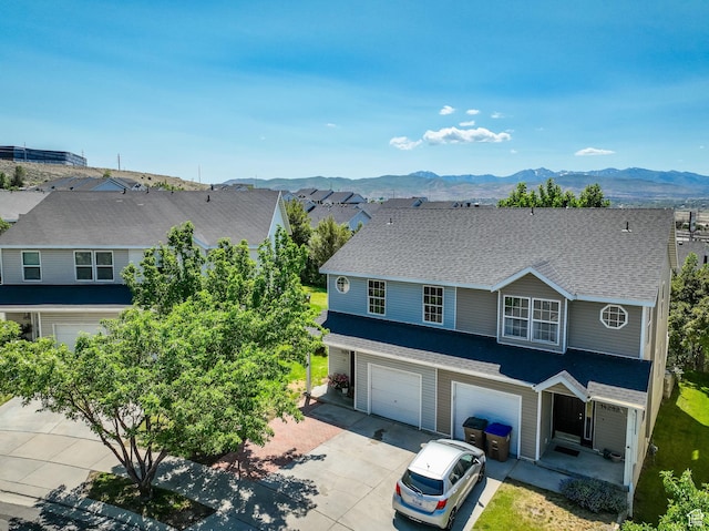 14284 S Daisyfield Dr E, Draper, UT 84020 - view of front of home featuring a garage, driveway, a mountain view, and roof with shingles