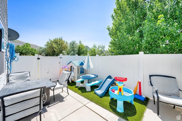 14284 S Daisyfield Dr E, Draper, UT 84020 - fenced backyard featuring a patio area, outdoor dining space, and a gate