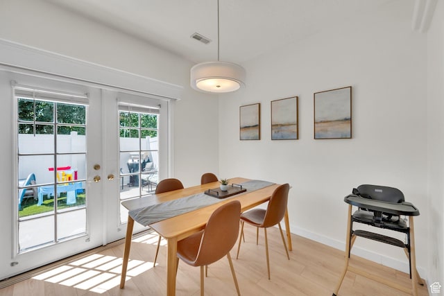 14284 S Daisyfield Dr E, Draper, UT 84020 - dining space with french doors, light wood finished floors, and baseboards