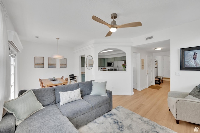 14284 S Daisyfield Dr E, Draper, UT 84020 - living room featuring light wood finished floors, a ceiling fan, and baseboards
