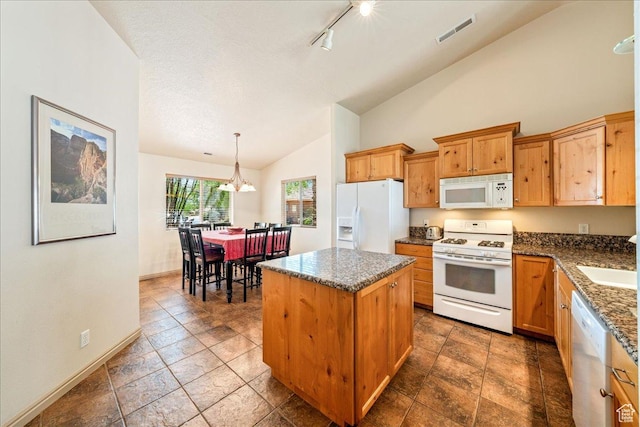 1173 W Snow Canyon Pkwy Unit 30, St George, UT 84770 - kitchen with white appliances, a center island, baseboards, pendant lighting, and dark stone counters