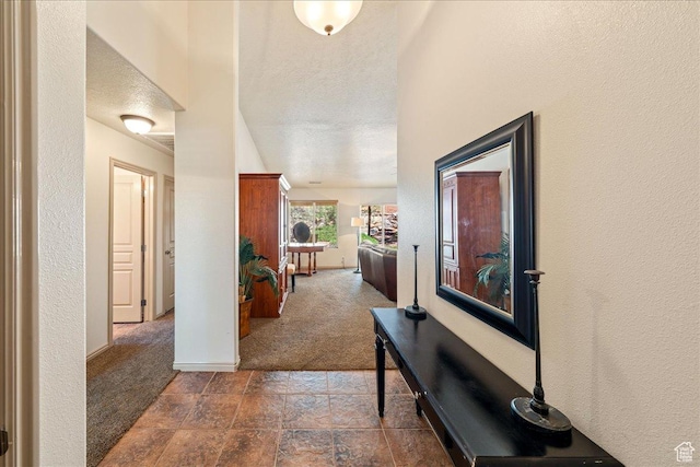 1173 W Snow Canyon Pkwy Unit 30, St George, UT 84770 - hall featuring carpet flooring, baseboards, stone finish floors, and a textured wall