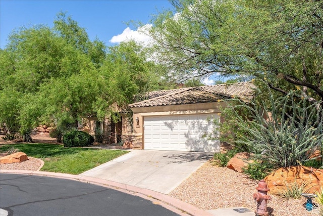 1173 W Snow Canyon Pkwy Unit 30, St George, UT 84770 - view of property hidden behind natural elements featuring stone siding, concrete driveway, a tile roof, a garage, and a front lawn