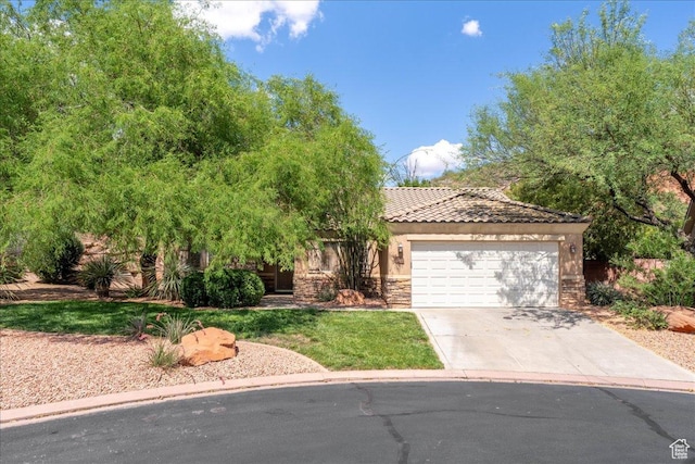 1173 W Snow Canyon Pkwy Unit 30, St George, UT 84770 - view of property hidden behind natural elements with an attached garage, concrete driveway, a tile roof, stone siding, and stucco siding