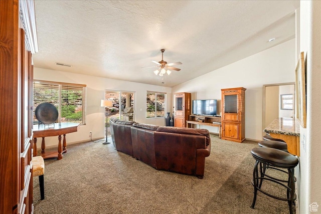 1173 W Snow Canyon Pkwy Unit 30, St George, UT 84770 - living room featuring light colored carpet, lofted ceiling, ceiling fan, baseboards, and a textured ceiling