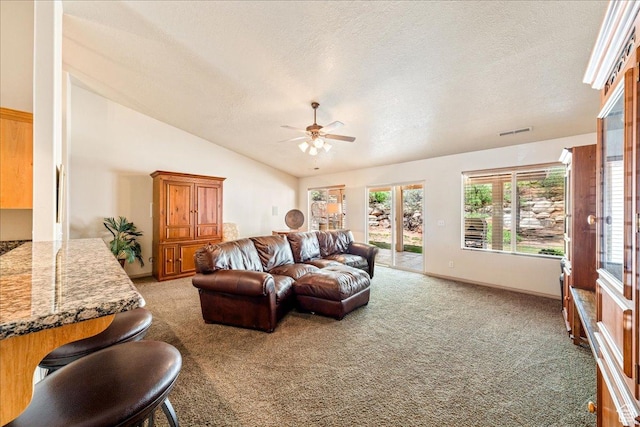 1173 W Snow Canyon Pkwy Unit 30, St George, UT 84770 - living area with a ceiling fan, light colored carpet, a textured ceiling, lofted ceiling, and baseboards