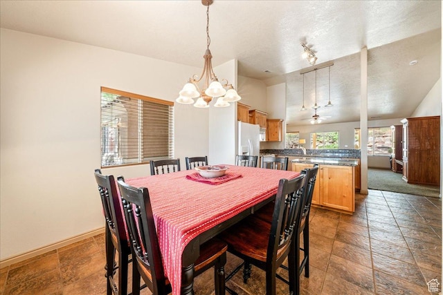 1173 W Snow Canyon Pkwy Unit 30, St George, UT 84770 - dining room featuring a chandelier, a textured ceiling, baseboards, lofted ceiling, and ceiling fan