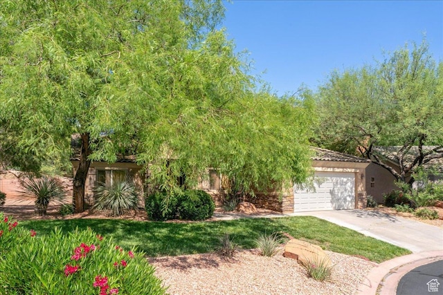 1173 W Snow Canyon Pkwy Unit 30, St George, UT 84770 - obstructed view of property with an attached garage, concrete driveway, and stucco siding