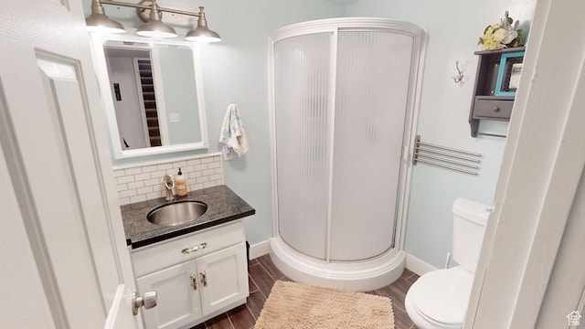 540 E 990 N, Pleasant Grove, UT 84062 - bathroom with a stall shower, vanity, toilet, wood finished floors, and backsplash