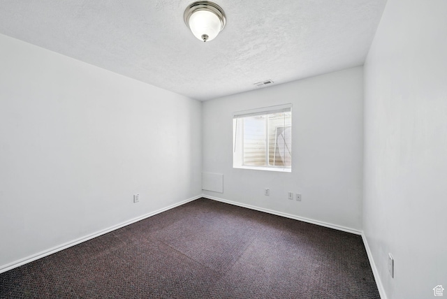 13708 S Manas Ct, Herriman, UT 84096 - empty room featuring dark carpet, baseboards, and a textured ceiling