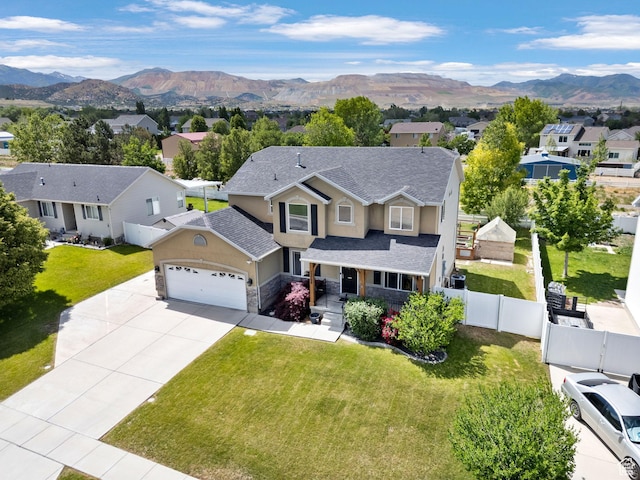 13708 S Manas Ct, Herriman, UT 84096 - traditional-style home with an attached garage, a residential view, concrete driveway, stucco siding, and a mountain view