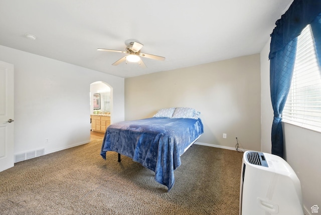 13708 S Manas Ct, Herriman, UT 84096 - carpeted bedroom with arched walkways, a ceiling fan, baseboards, and ensuite bath