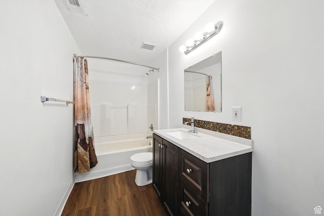 13708 S Manas Ct, Herriman, UT 84096 - bathroom with vanity, wood finished floors, shower / bathtub combination with curtain, toilet, and a textured ceiling