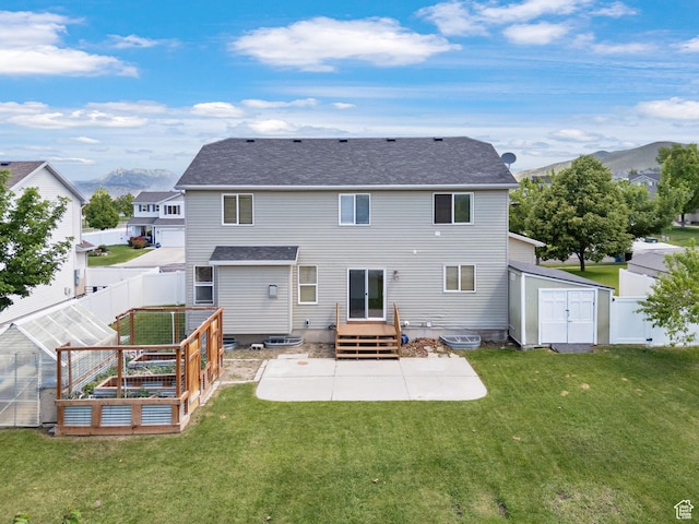 13708 S Manas Ct, Herriman, UT 84096 - rear view of house featuring a patio area, a garden, a mountain view, and roof with shingles