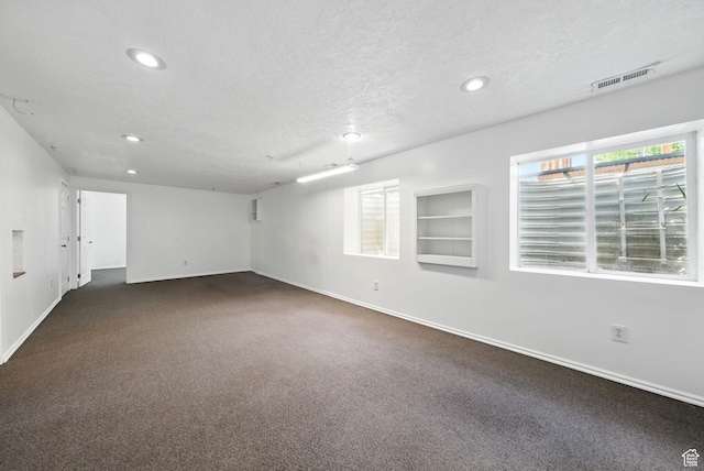 13708 S Manas Ct, Herriman, UT 84096 - spare room with baseboards, recessed lighting, dark colored carpet, a textured ceiling, and built in features