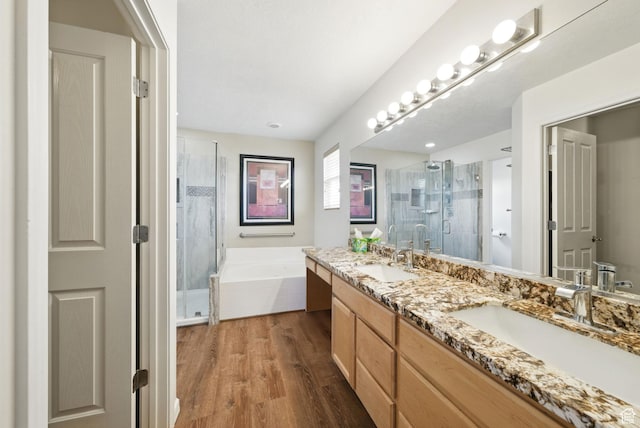 13708 S Manas Ct, Herriman, UT 84096 - full bathroom featuring double vanity, a stall shower, a bath, and wood finished floors