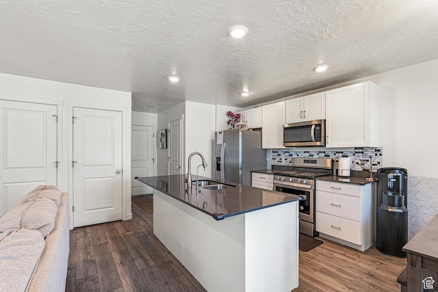 3970 W Cool Spring Ave, Lehi, UT 84043 - kitchen featuring appliances with stainless steel finishes, dark countertops, dark wood-style flooring, a sink, and a textured ceiling