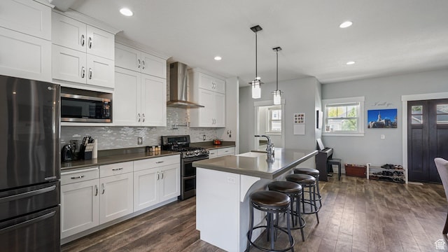 225 W 1390 N, Orem, UT 84057 - kitchen featuring appliances with stainless steel finishes, wall chimney exhaust hood, dark countertops, dark wood-type flooring, and tasteful backsplash