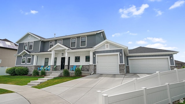 225 W 1390 N, Orem, UT 84057 - view of front of property featuring board and batten siding, an attached garage, driveway, and stone siding