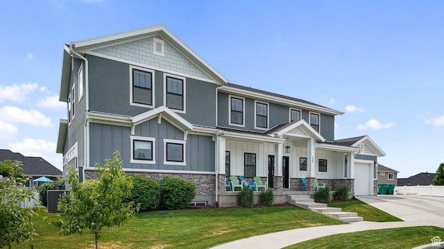 225 W 1390 N, Orem, UT 84057 - view of front of home with board and batten siding, concrete driveway, stone siding, a front yard, and an attached garage