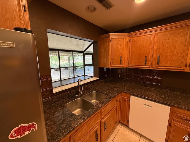 1144 W Bloomington Dr S, St George, UT 84790 - kitchen with white dishwasher, a sink, vaulted ceiling, and brown cabinetry