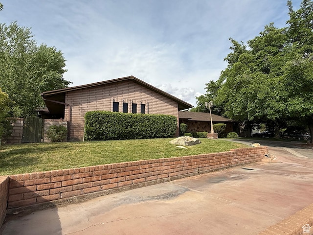 1144 W Bloomington Dr S, St George, UT 84790 - view of side of property with concrete driveway and a yard