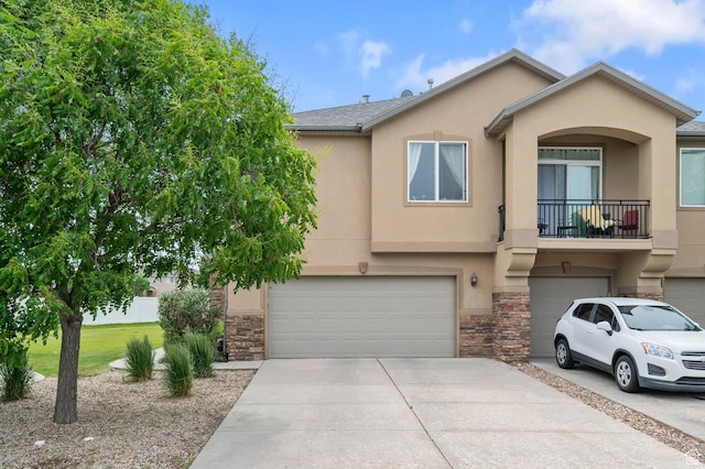 4699 W Greensand Dr S, West Jordan, UT 84084 - view of front facade with an attached garage, stone siding, driveway, stucco siding, and a balcony