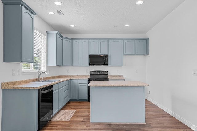 4699 W Greensand Dr S, West Jordan, UT 84084 - kitchen with black appliances, a sink, recessed lighting, a kitchen island, and a textured ceiling