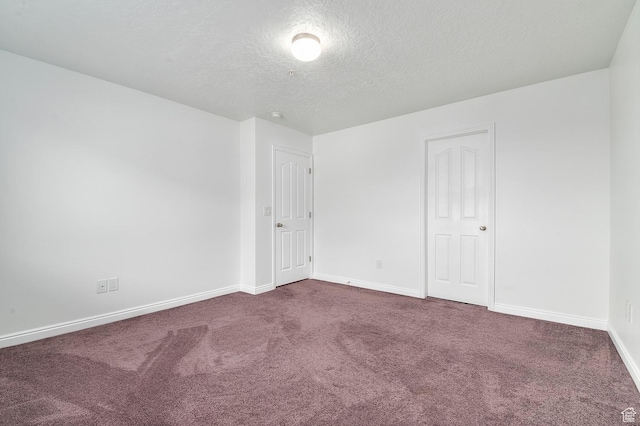 4699 W Greensand Dr S, West Jordan, UT 84084 - unfurnished room featuring a textured ceiling, dark colored carpet, and baseboards