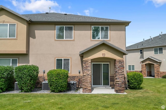 4699 W Greensand Dr S, West Jordan, UT 84084 - rear view of property with stucco siding, central air condition unit, and a lawn