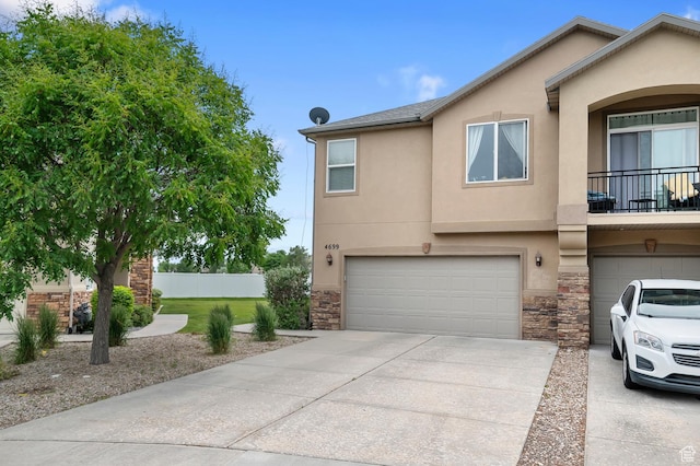 4699 W Greensand Dr S, West Jordan, UT 84084 - multi unit property featuring a garage, stucco siding, stone siding, and driveway