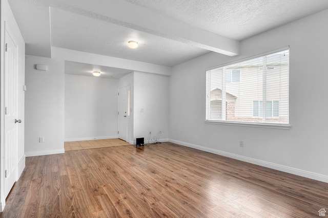4699 W Greensand Dr S, West Jordan, UT 84084 - unfurnished room featuring wood finished floors, a textured ceiling, and baseboards