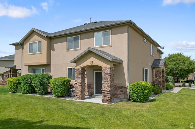 4699 W Greensand Dr S, West Jordan, UT 84084 - view of front of property with stucco siding, stone siding, and a front lawn