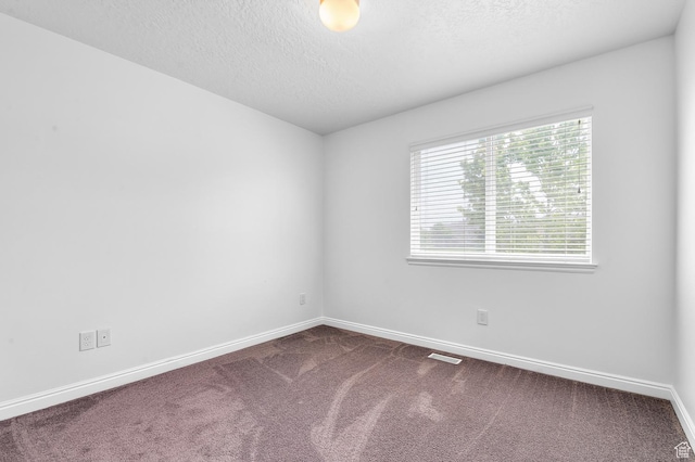4699 W Greensand Dr S, West Jordan, UT 84084 - empty room with dark carpet, baseboards, and a textured ceiling
