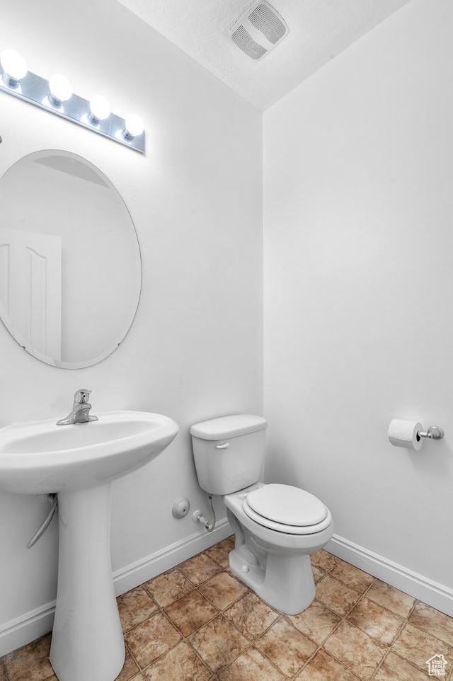 4699 W Greensand Dr S, West Jordan, UT 84084 - bathroom featuring toilet, baseboards, and a sink