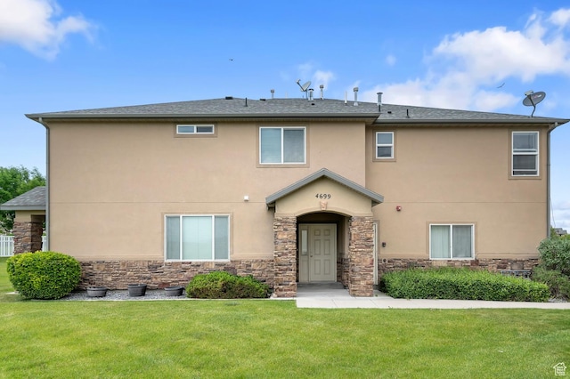 4699 W Greensand Dr S, West Jordan, UT 84084 - view of front of property with stone siding, stucco siding, and a front yard