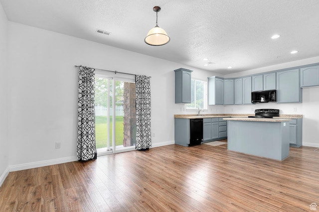 4699 W Greensand Dr S, West Jordan, UT 84084 - kitchen featuring black appliances, a textured ceiling, light countertops, wood finished floors, and baseboards