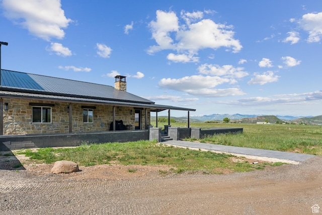 2711 S 500 E, Francis, UT 84036 - back of property featuring a chimney, stone siding, metal roof, and a mountain view