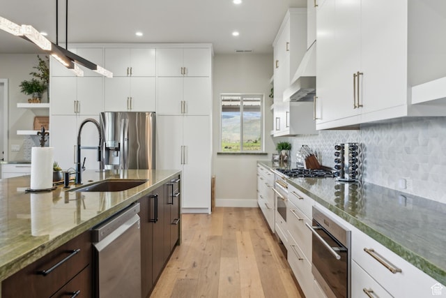 2711 S 500 E, Francis, UT 84036 - kitchen featuring stainless steel appliances, a sink, wall chimney exhaust hood, recessed lighting, and light wood-style flooring