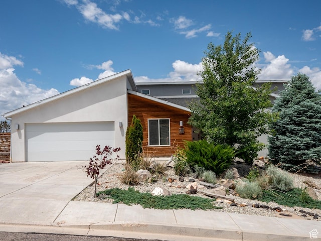 48 S Cimarron Cir, Cedar City, UT 84720 - view of front of property with an attached garage, driveway, and stucco siding
