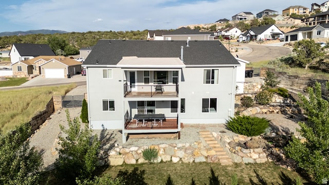 48 S Cimarron Cir, Cedar City, UT 84720 - back of house featuring a balcony, a residential view, stucco siding, and a wooden deck