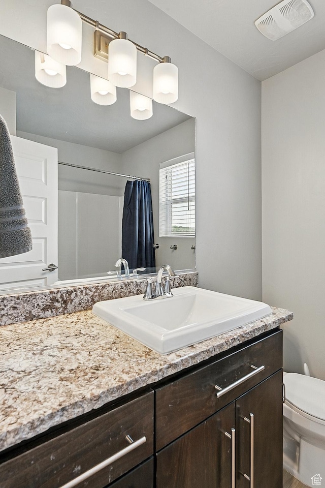 48 S Cimarron Cir, Cedar City, UT 84720 - bathroom with vanity, toilet, and a shower with shower curtain