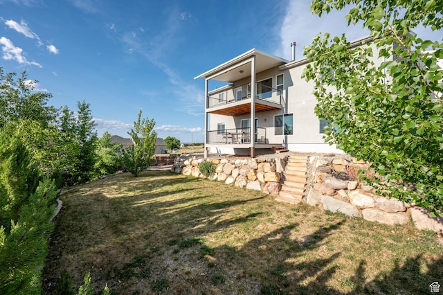 48 S Cimarron Cir, Cedar City, UT 84720 - back of house featuring a balcony and a lawn